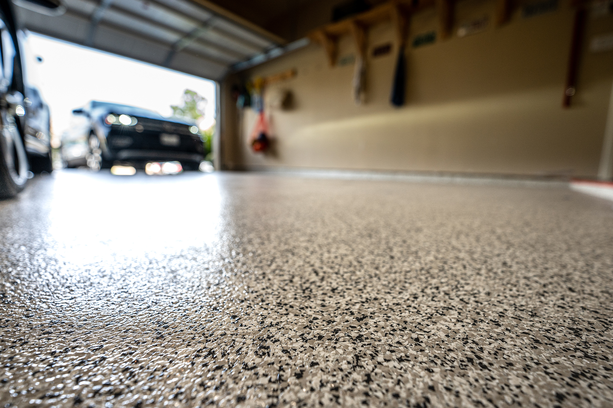 Technician inspecting commercial epoxy flooring texture inside a Bergen County - NJ service facility