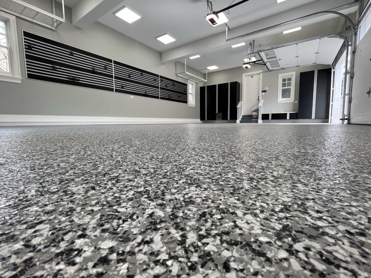 Commercial Epoxy Flooring in Bergen County - NJ being applied as a crew coats a prepared warehouse aisle